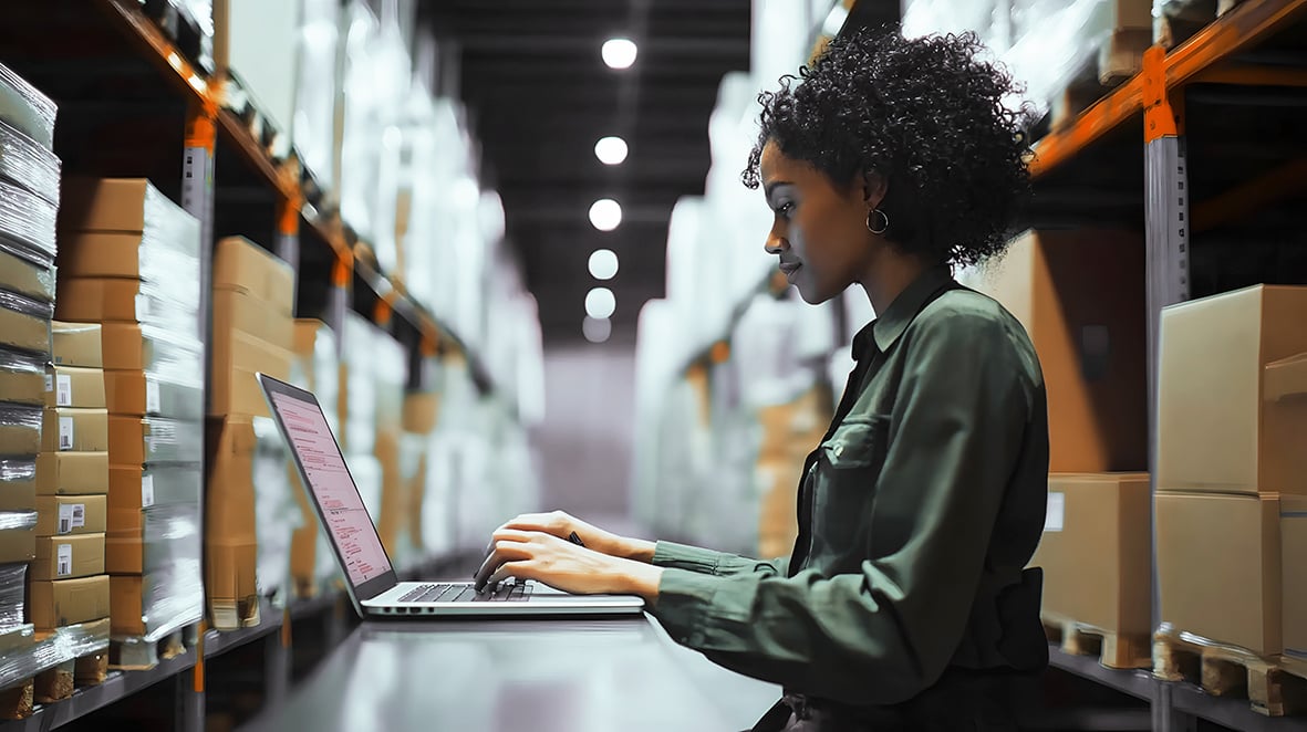 woman-working-laptop-warehouse-night