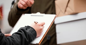 Close-up of signing for a package