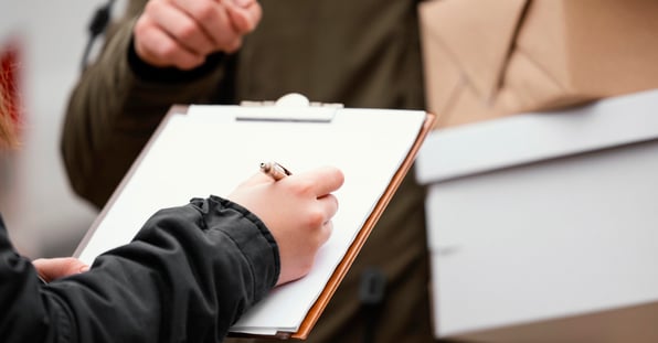 Close-up of signing for a package