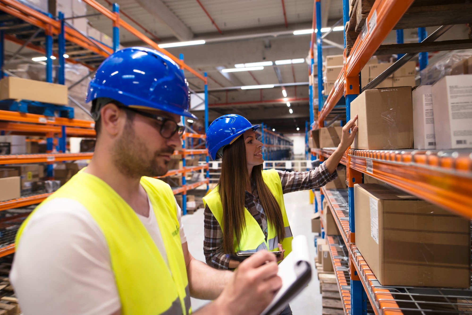 coworkers-checking-inventory-large-warehouse-storage-department coworkers-checking-inventory-large-warehouse-storage-department