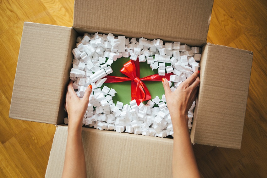 Woman hands opening a parcel contains a gift